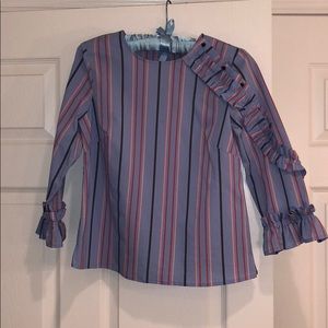 Cute striped blouse with ruffle and buttons.